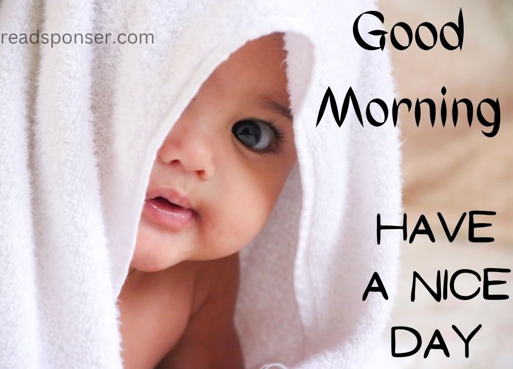 A cute child is looking up out of the towel and giving you a cute morning