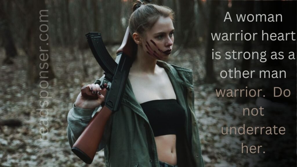 A daring looking girl holding a gun in her hands and have some scratches on her cheeks is standing in a forest and messaging about the warrior woman in this morning